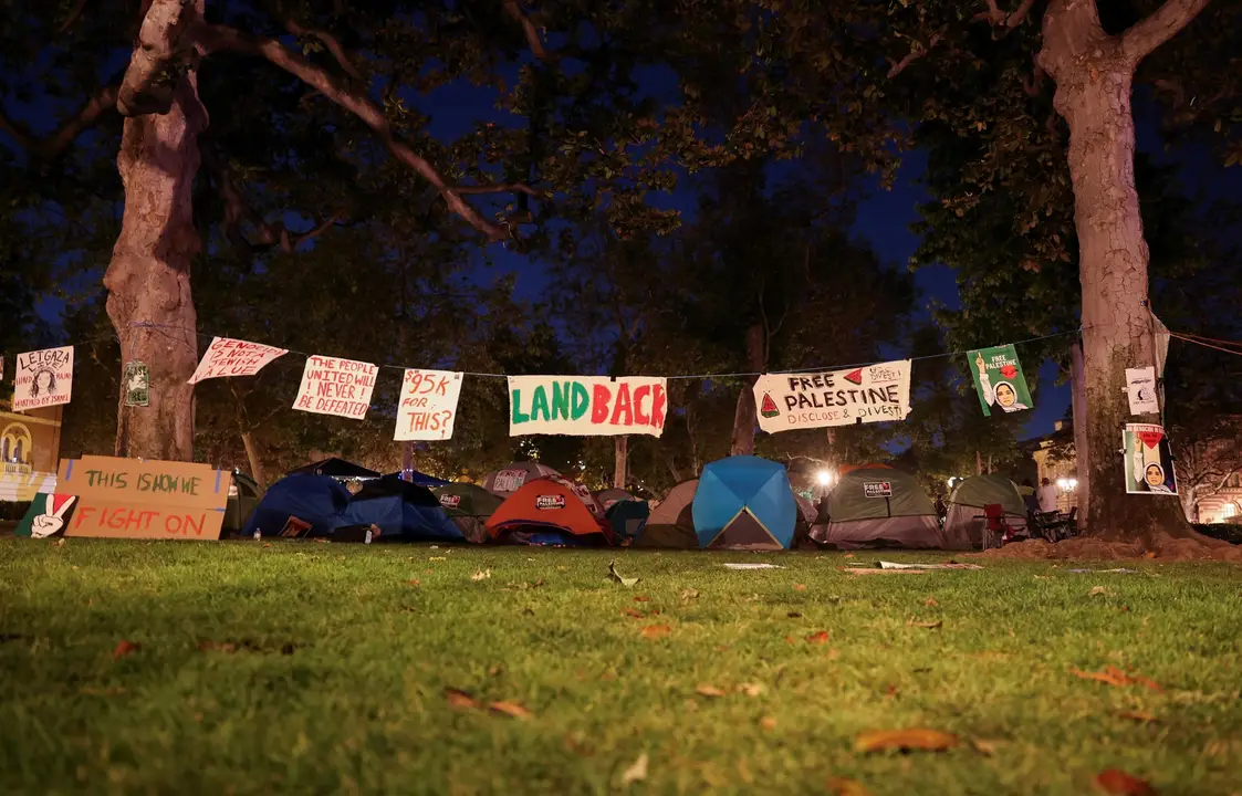 PHOTO: Posters hang near tents at the University of Southern California (USC) during a protest in support of Palestinians in Gaza, amid the ongoing conflict between Israel and the Palestinian Islamist group Hamas, in Los Angeles, on April 27, 2024. 